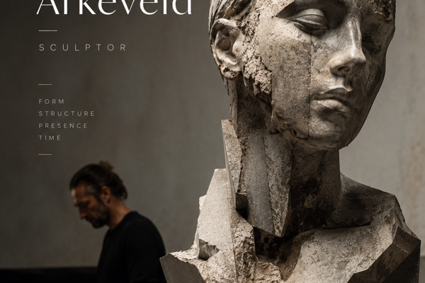 Angular stone bust sculpture by Damian Arkeveld with the artist working in studio background